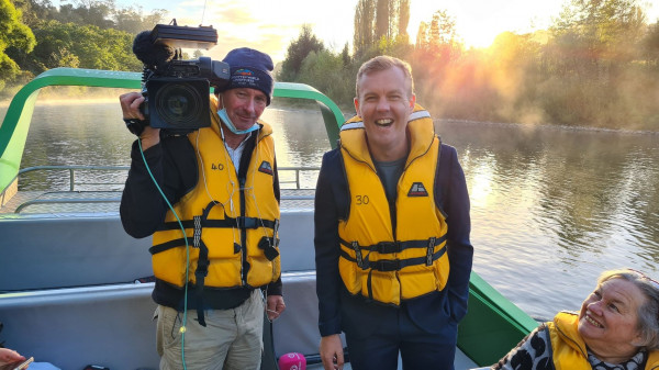 Film crew on jetboat during sunrise